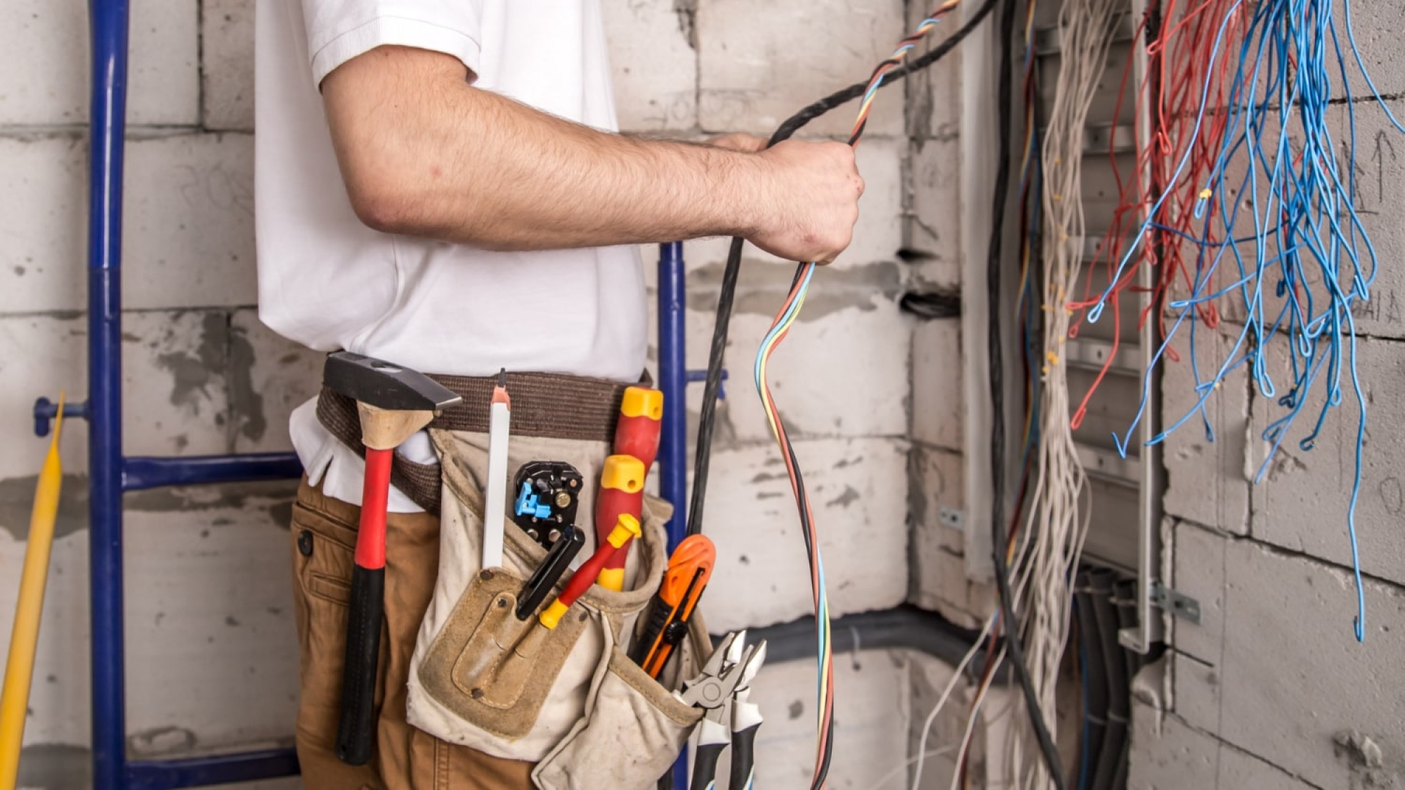electrician-working-near-board-with-wires-installation-connection-electrics-min